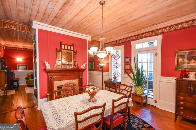 dining space with a notable chandelier, crown molding, dark hardwood / wood-style flooring, and wooden ceiling