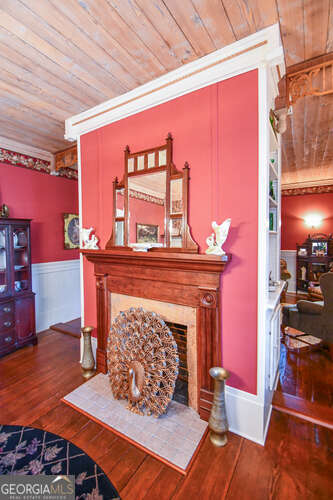 living room featuring wood ceiling, wood-type flooring, and ornamental molding