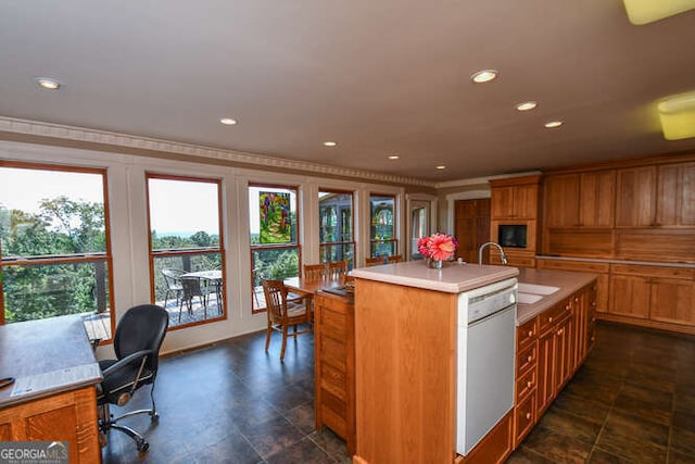 kitchen featuring dishwasher, a kitchen island with sink, and sink