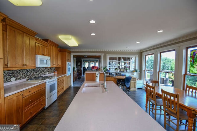 kitchen with sink, white appliances, and decorative backsplash