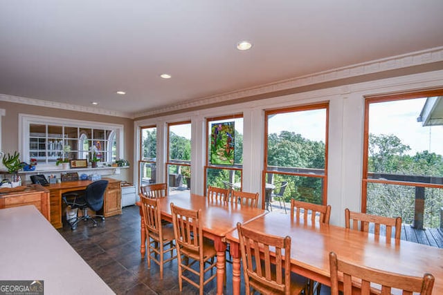 dining space with crown molding