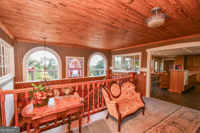 sitting room with wooden ceiling, a healthy amount of sunlight, and a notable chandelier