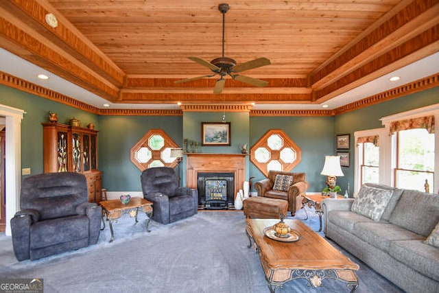 carpeted living room featuring ceiling fan, a raised ceiling, and wooden ceiling