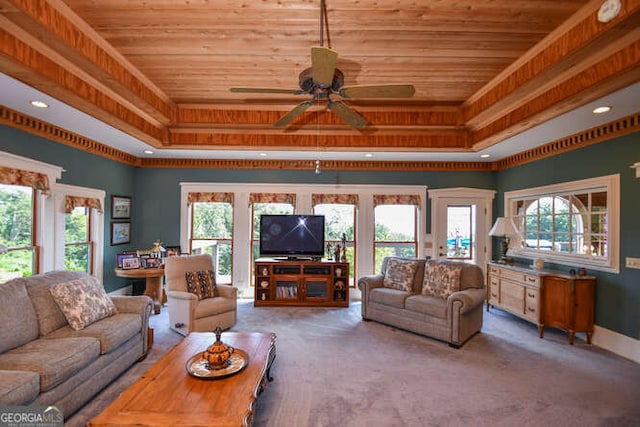 living room featuring ceiling fan, a raised ceiling, and plenty of natural light