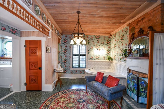 living area featuring wood ceiling, a wealth of natural light, washer / dryer, and a notable chandelier