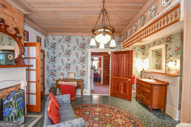 interior space featuring wooden ceiling, crown molding, french doors, sink, and a chandelier