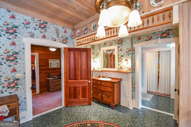 interior space featuring vanity, wooden walls, and wooden ceiling