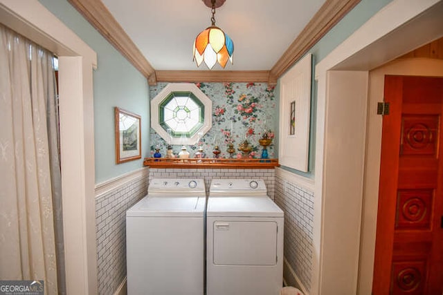 laundry area with separate washer and dryer, tile walls, and ornamental molding