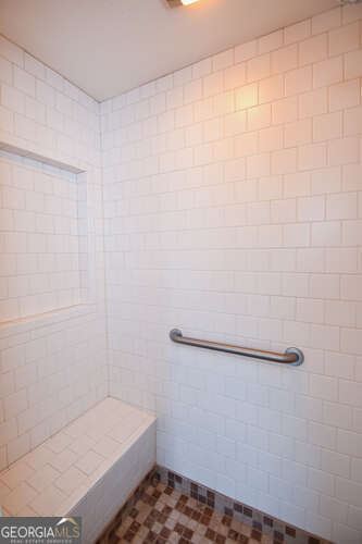 bathroom with tiled shower