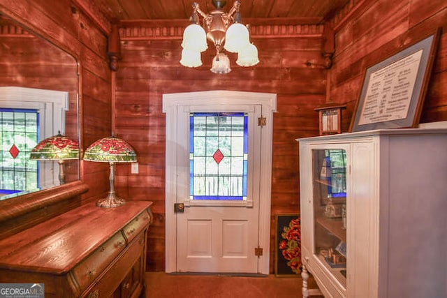 entryway featuring wooden ceiling, wood walls, and a notable chandelier