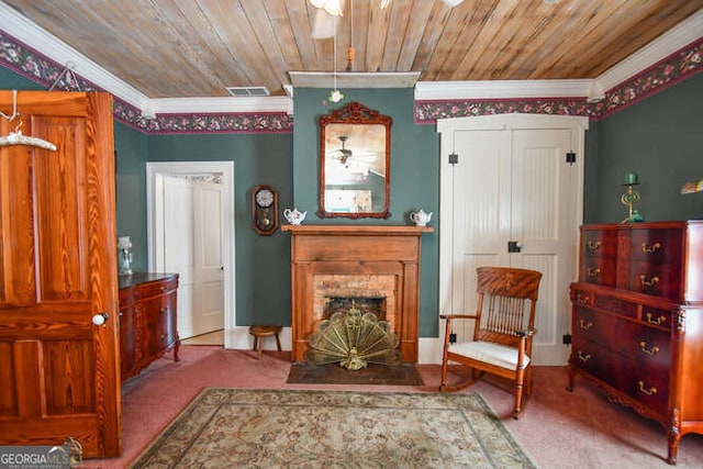 living area with wood ceiling, carpet flooring, and ornamental molding