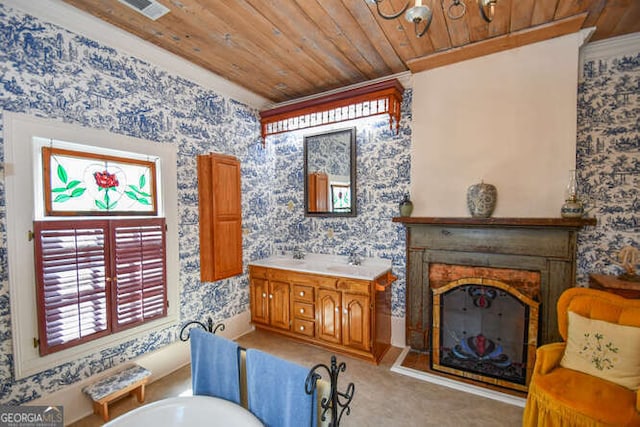 interior space with wooden ceiling, crown molding, and vanity