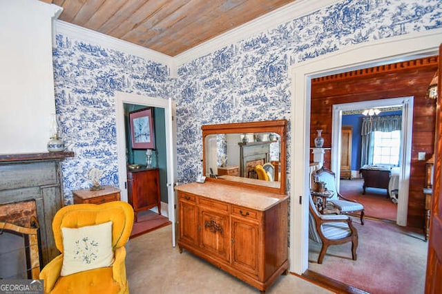 sitting room featuring wood ceiling, light carpet, a fireplace, and crown molding