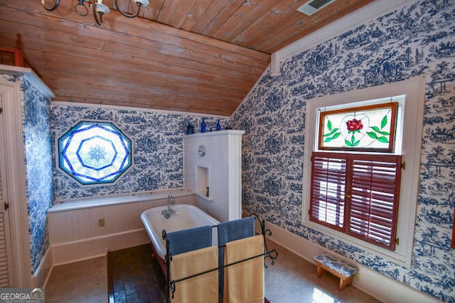 interior space with lofted ceiling, a bath, and wooden ceiling