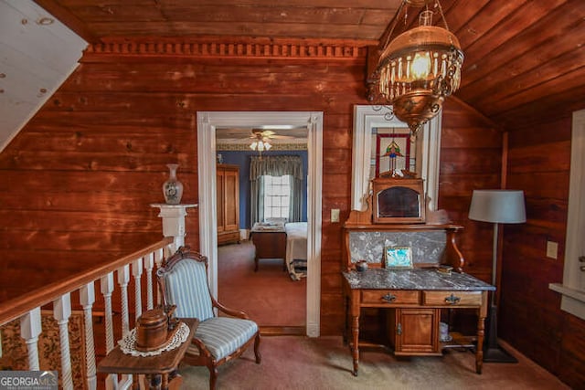 interior space with dark colored carpet, wood walls, and wooden ceiling