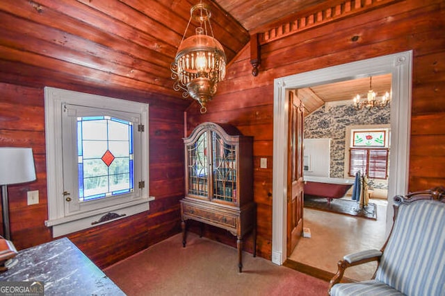 bedroom with lofted ceiling, wood walls, a chandelier, and wood ceiling