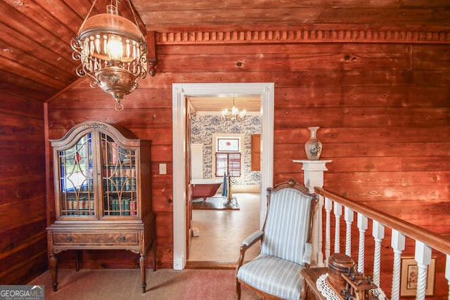 sitting room with wooden walls, wood ceiling, vaulted ceiling, and a notable chandelier