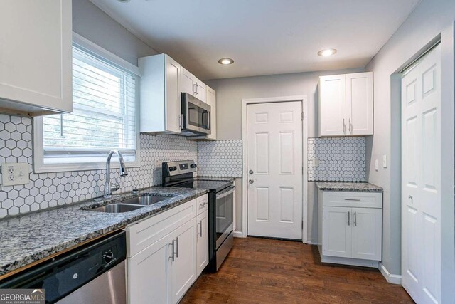 2836 Harlan Dr, Atlanta, GA 30344 - kitchen with white cabinets, stainless steel appliances, a sink, stone counters, and dark wood-style floors