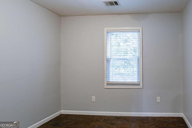 2836 Harlan Dr, Atlanta, GA 30344 - empty room featuring dark wood-style flooring, visible vents, baseboards, and a wealth of natural light