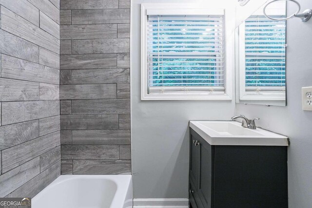 2836 Harlan Dr, Atlanta, GA 30344 - full bathroom with baseboards, vanity, and shower / bathtub combination