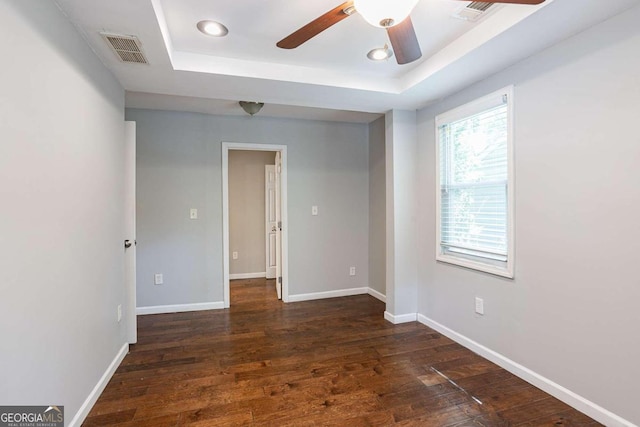 2836 Harlan Dr, Atlanta, GA 30344 - unfurnished room with a raised ceiling, dark wood-type flooring, baseboards, and visible vents