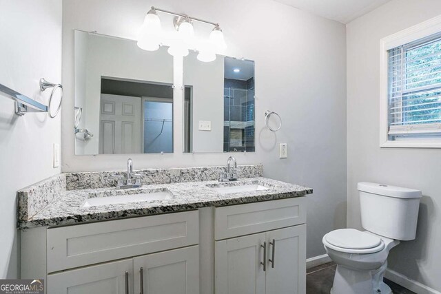 2836 Harlan Dr, Atlanta, GA 30344 - bathroom with toilet, a sink, double vanity, and a shower stall