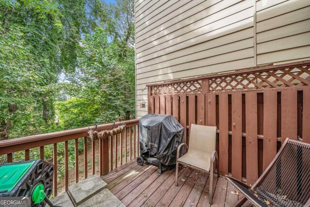 wooden deck featuring area for grilling