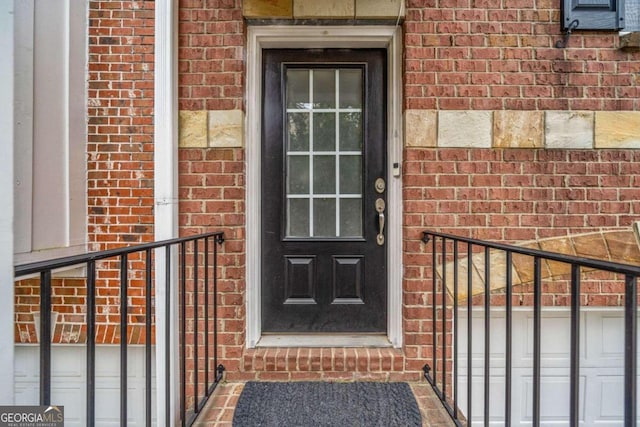 doorway to property featuring a balcony and a garage