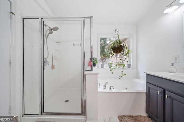 bathroom featuring independent shower and bath and vanity