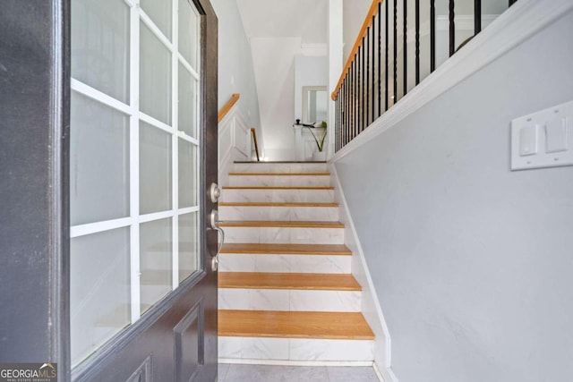 staircase featuring tile patterned floors