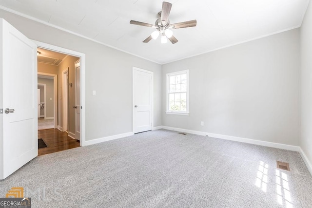 unfurnished bedroom with ceiling fan, carpet floors, and crown molding