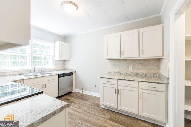 kitchen featuring white cabinetry, tasteful backsplash, light wood-type flooring, stainless steel dishwasher, and sink