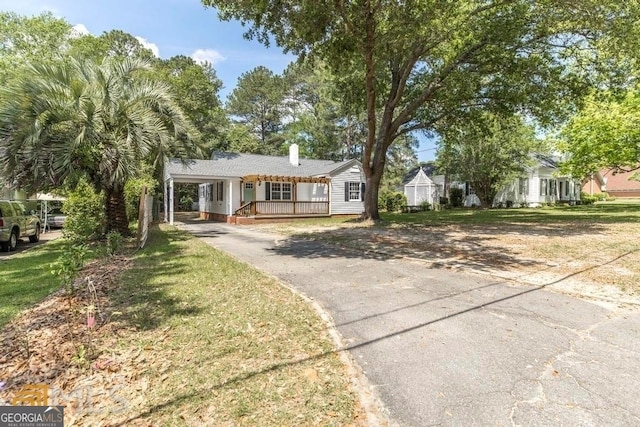 single story home with a porch and a front yard