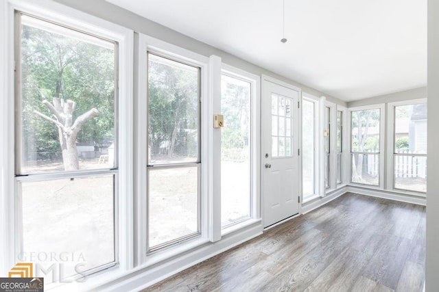 unfurnished sunroom featuring a wealth of natural light