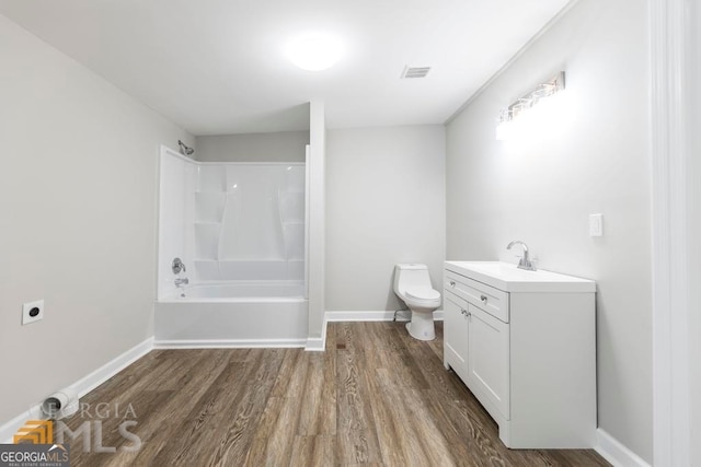 full bathroom with vanity, hardwood / wood-style flooring, tub / shower combination, and toilet