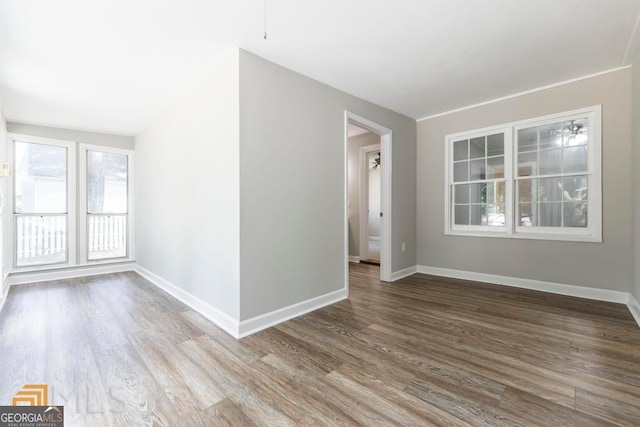 unfurnished room with hardwood / wood-style flooring