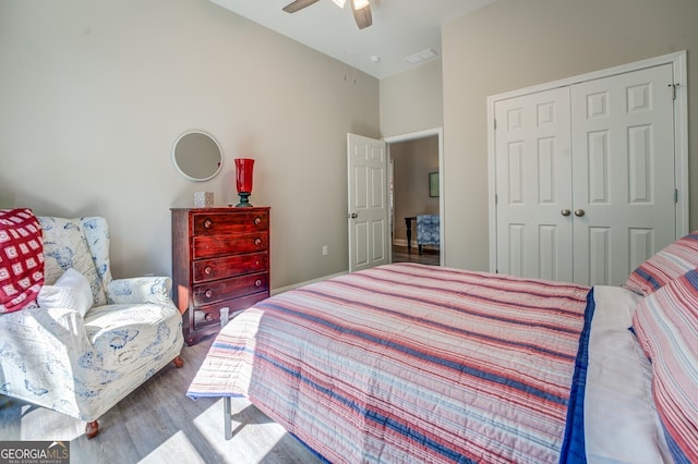 bedroom with ceiling fan, hardwood / wood-style flooring, and a closet