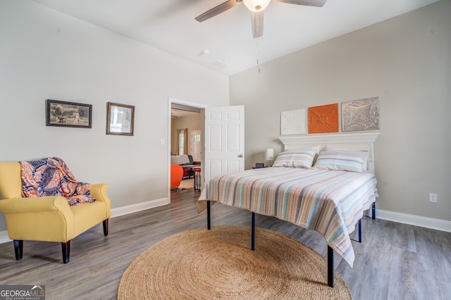 bedroom with ceiling fan and hardwood / wood-style flooring