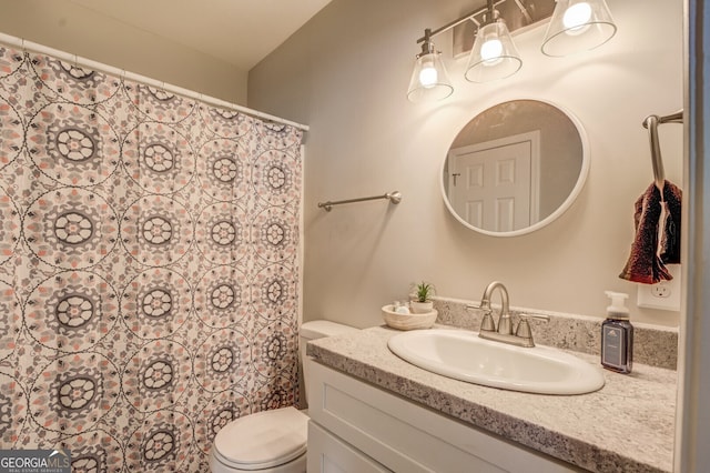 bathroom with vanity, toilet, and curtained shower