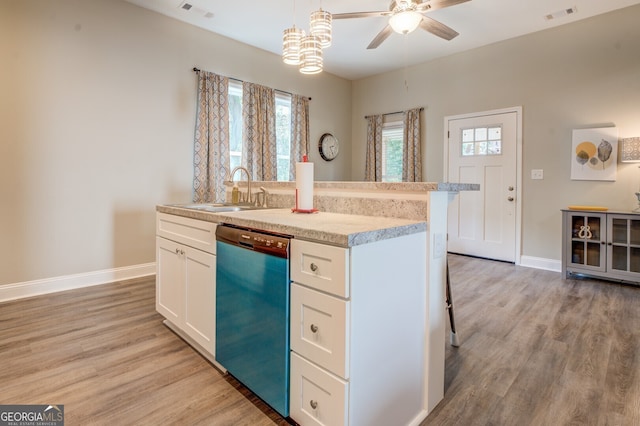 kitchen featuring hanging light fixtures, sink, white cabinetry, dishwasher, and light hardwood / wood-style floors