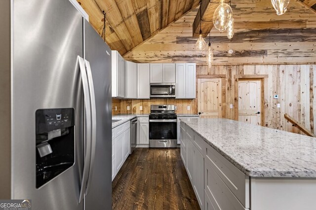 kitchen featuring light stone counters, dark wood-type flooring, white cabinetry, stainless steel appliances, and decorative light fixtures