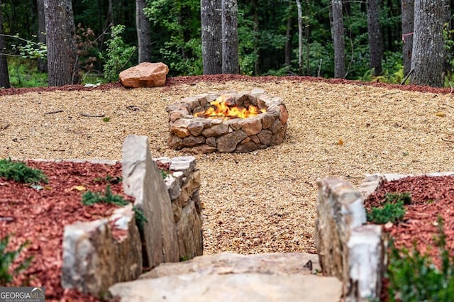 view of yard with an outdoor fire pit