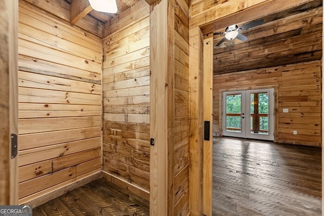 interior space with wooden walls, hardwood / wood-style flooring, and french doors