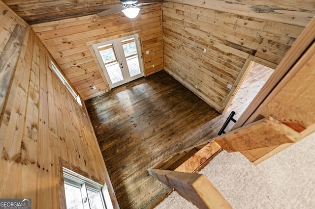 room details featuring wood walls, hardwood / wood-style floors, and ceiling fan