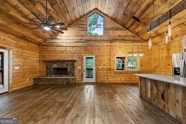 unfurnished living room featuring wooden ceiling, dark hardwood / wood-style floors, and a wealth of natural light