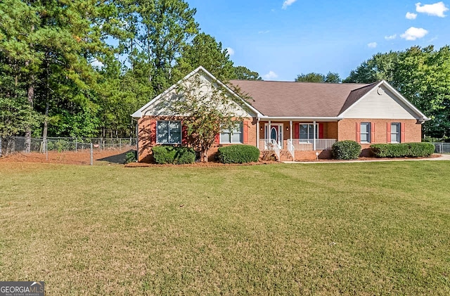 ranch-style home featuring a front yard and covered porch