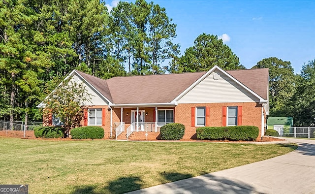 ranch-style house with a front lawn and covered porch