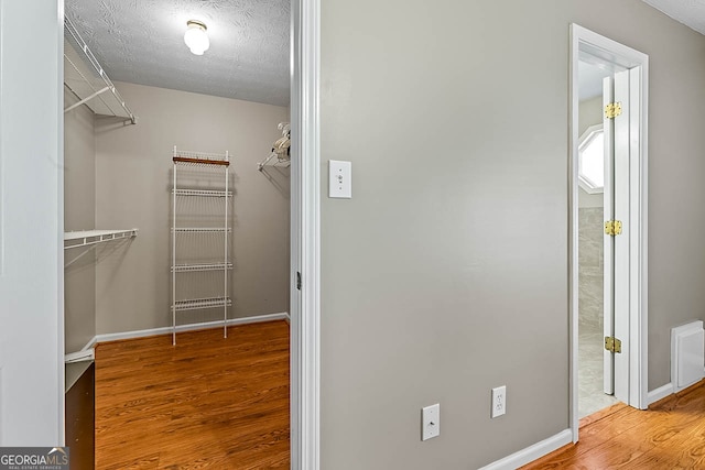 spacious closet featuring light wood-type flooring