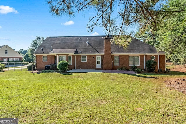 back of property with a patio and a yard