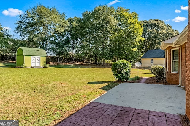 view of yard with a patio and a storage unit